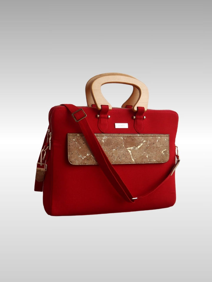 Woman carrying FOReT® Red Laptop Bag in canvas and FSC-certified cork with gold-flecked details – ethical luxury fashion