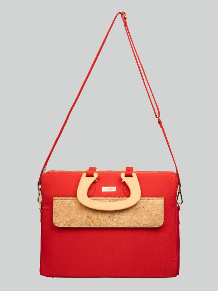 Woman carrying FOReT® Red Laptop Bag in canvas and FSC-certified cork with gold-flecked details – ethical luxury fashion